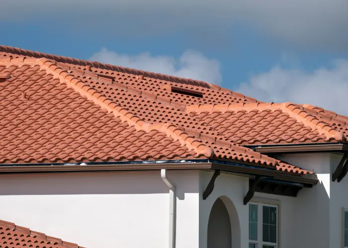 A orangish colored tile roof that was repaired