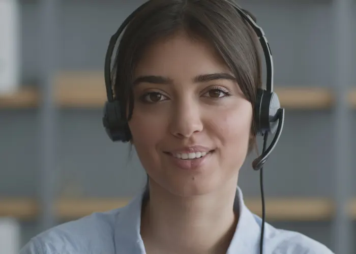 Wesley Chapel customer service representative- A young lady in a blue shirt wearing headphones